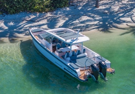 Modern luxury boat with elegant teak flooring and outdoor lounge areas viewed from above